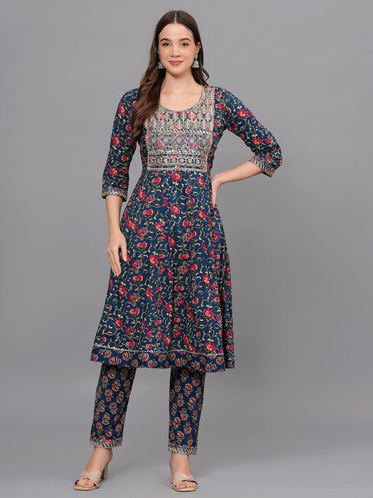 Woman wearing a floral dress and pants set on a gray background