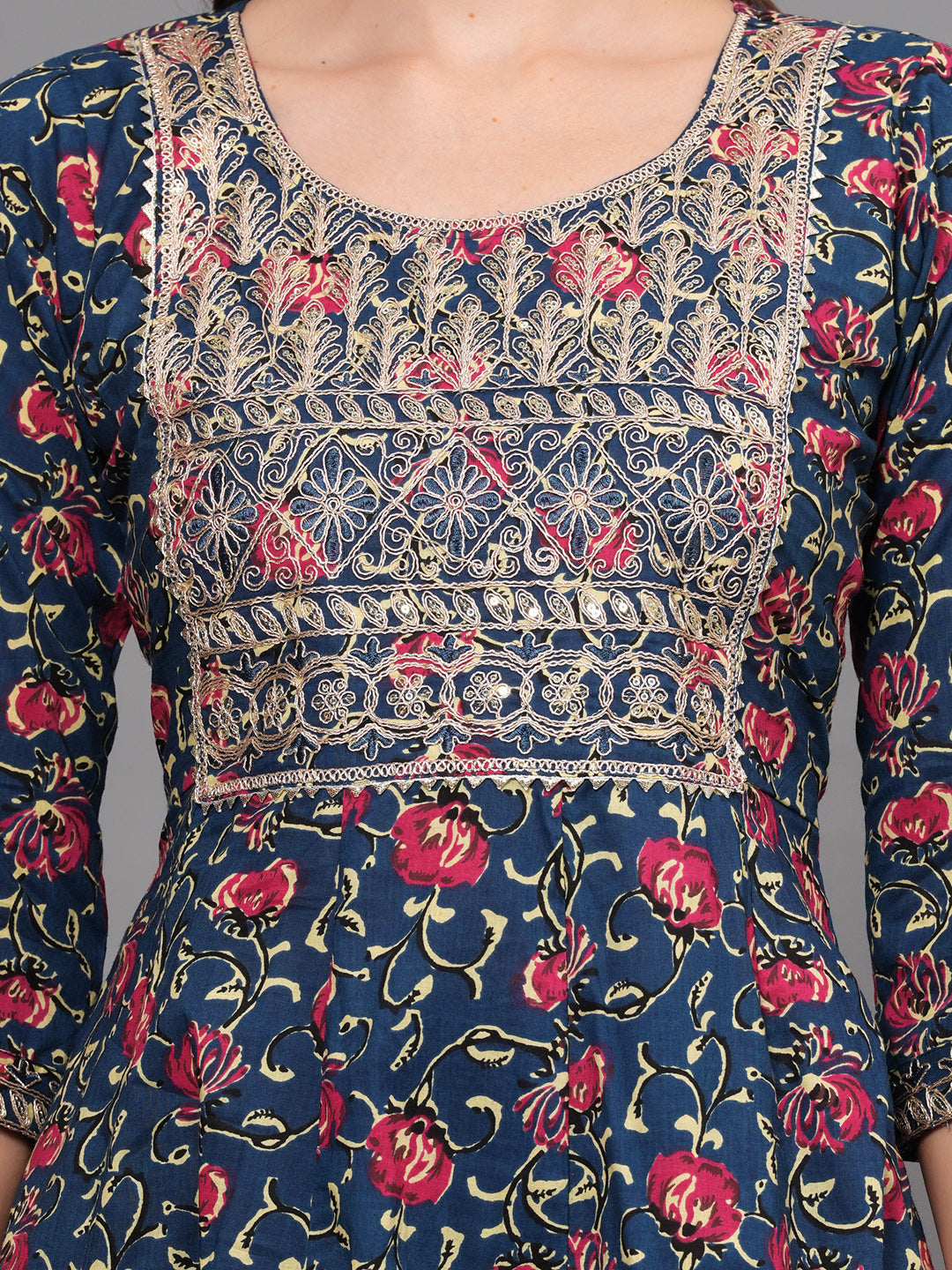 Floral patterned dress with intricate embroidery on a plain background