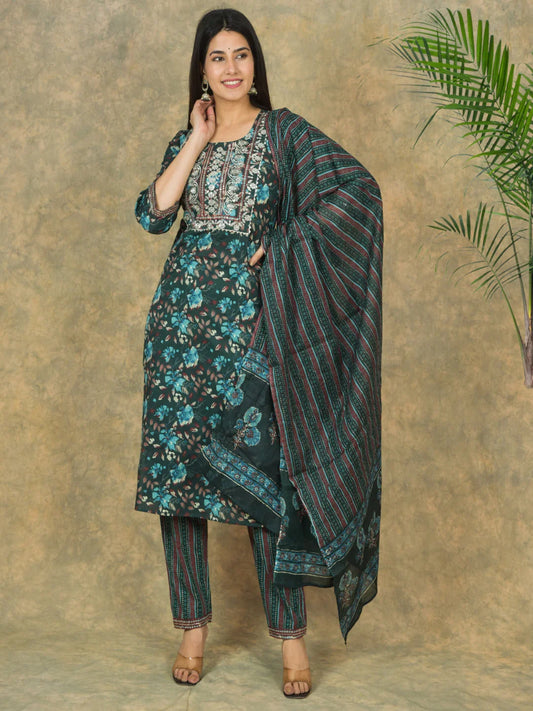 Woman wearing a traditional outfit with a floral pattern against a beige background