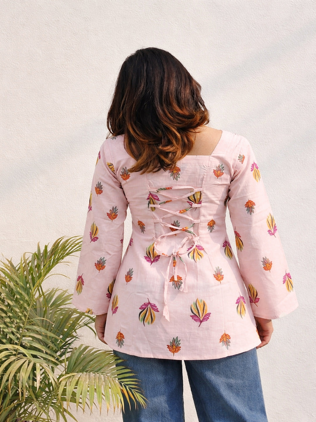 Back lace short kurti, adjustble back coret dori trendy kurti , full sleeve kurti top for girls , hip lenght kurti, square neck floral print kurti, pink floral kurti, bell sleeve regular kurti top, relaxed fit back dori kurti > Mitrika 