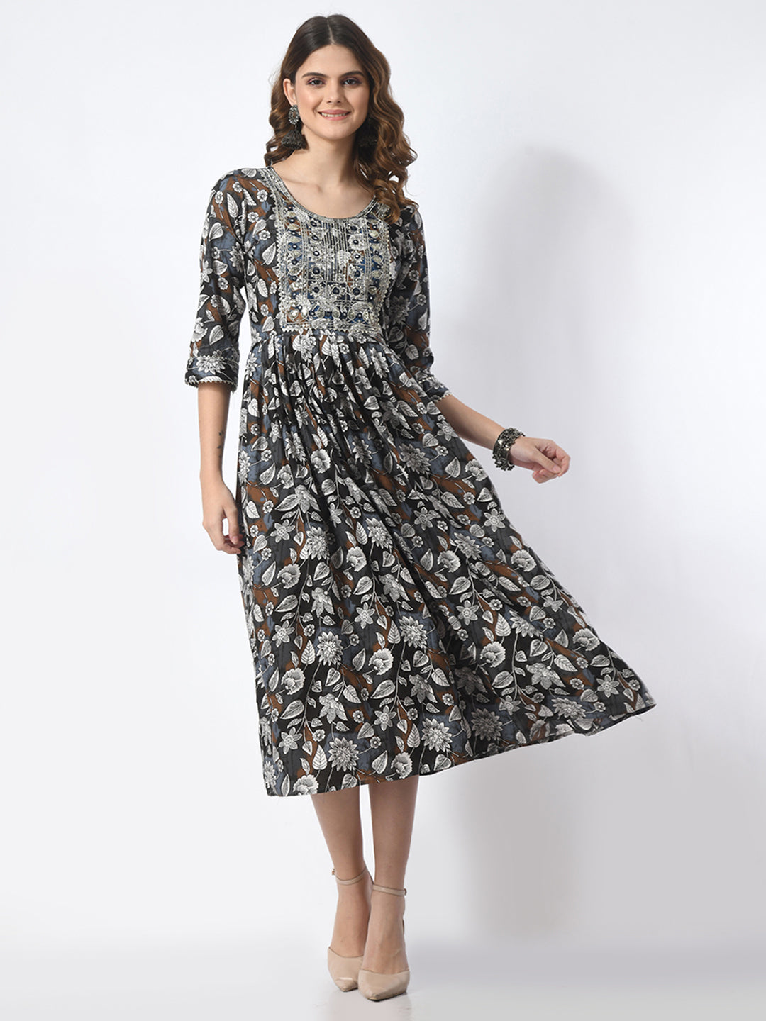 Woman wearing a patterned dress on a white background