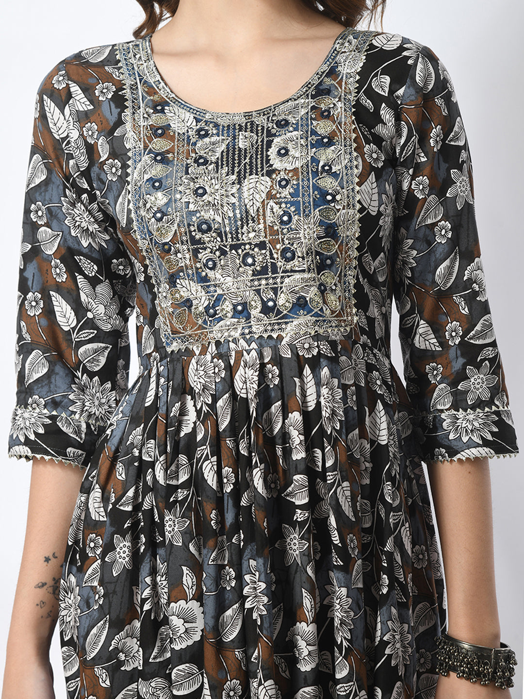 Floral patterned dress with intricate design on a plain background
