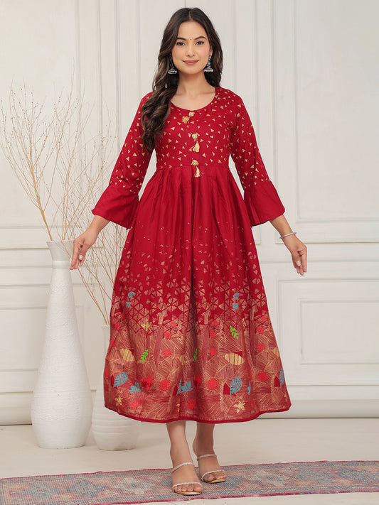 Woman wearing a red dress with floral patterns in a minimalistic >setting > Mitrika