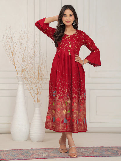 Woman wearing a red dress with floral patterns in a minimalistic setting