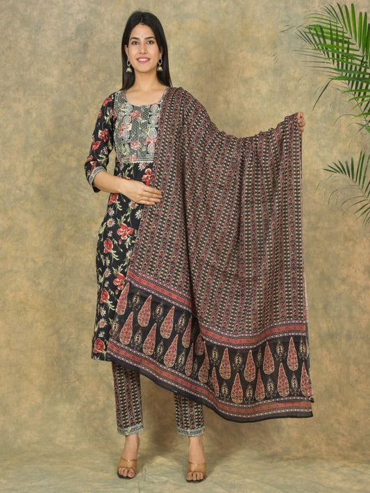 Woman holding a patterned dupatta against a textured wall > Mitrika
