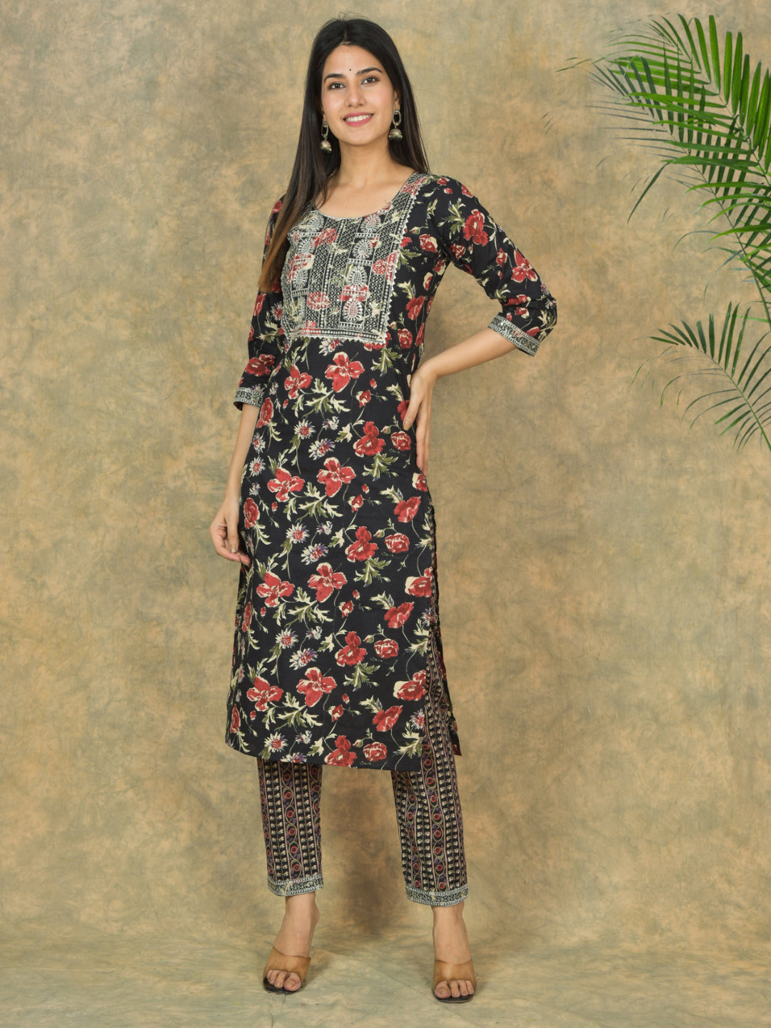 Woman wearing a floral kurta with pants against a textured beige background