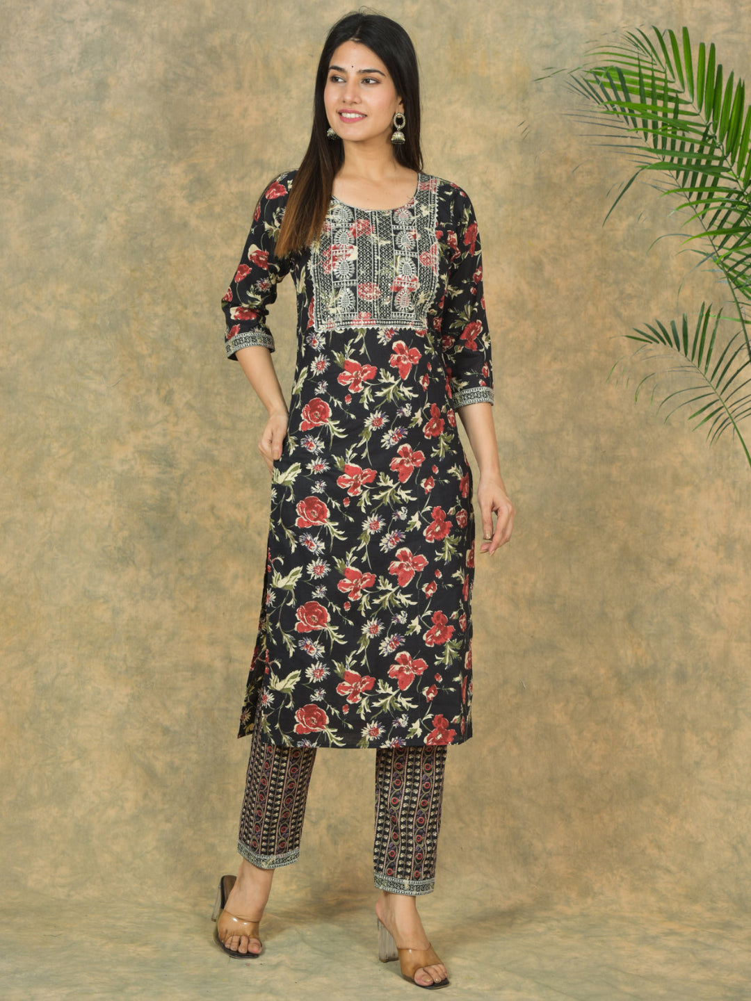 Woman wearing a floral kurta with a plain background