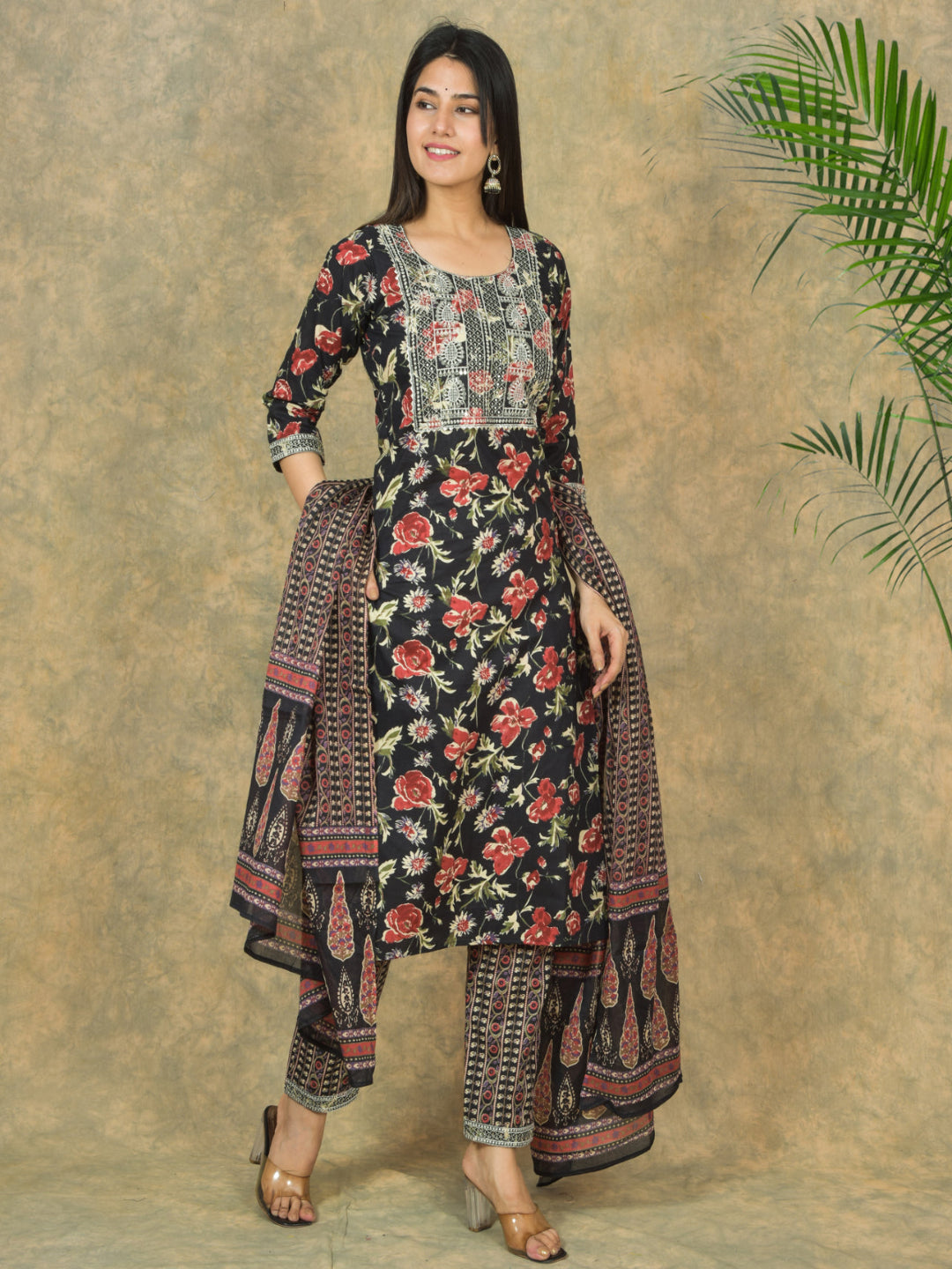 Woman wearing a floral traditional outfit with a plain background