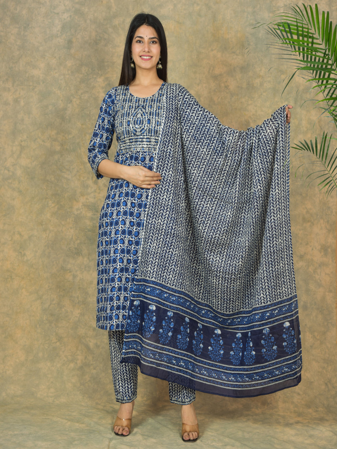 Woman holding a blue and white patterned dupatta against a beige background > Mitrika