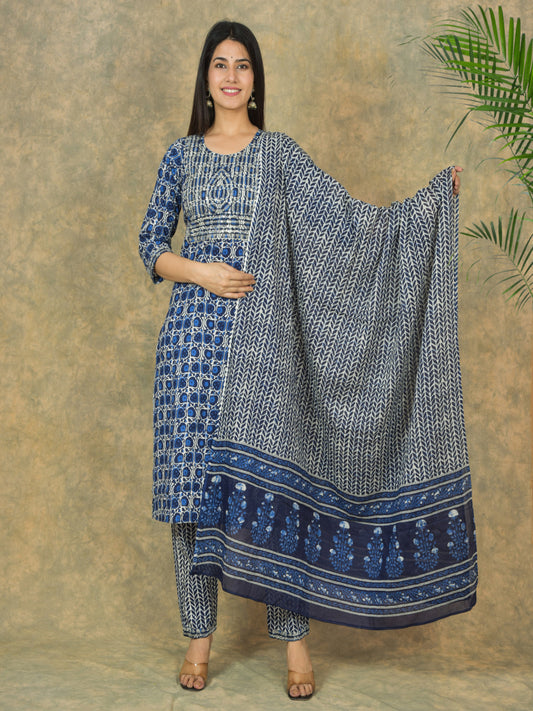 Woman holding a blue and white patterned dupatta against a beige background > Mitrika