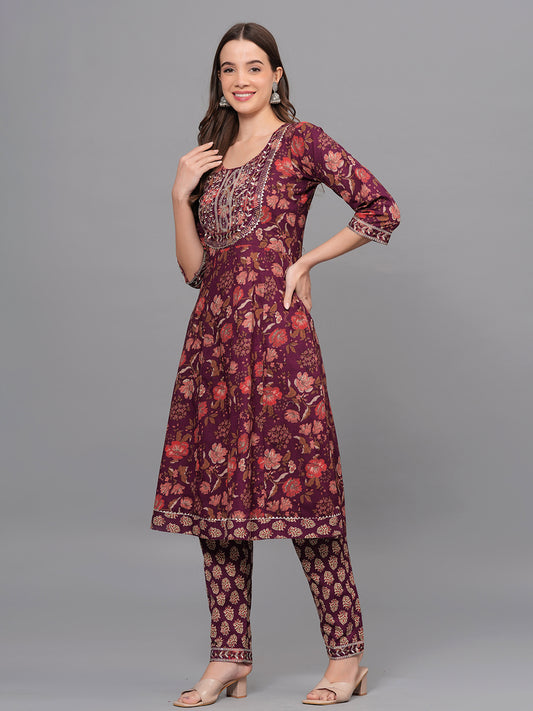 Woman wearing a maroon floral outfit on a gray background > Mitrika