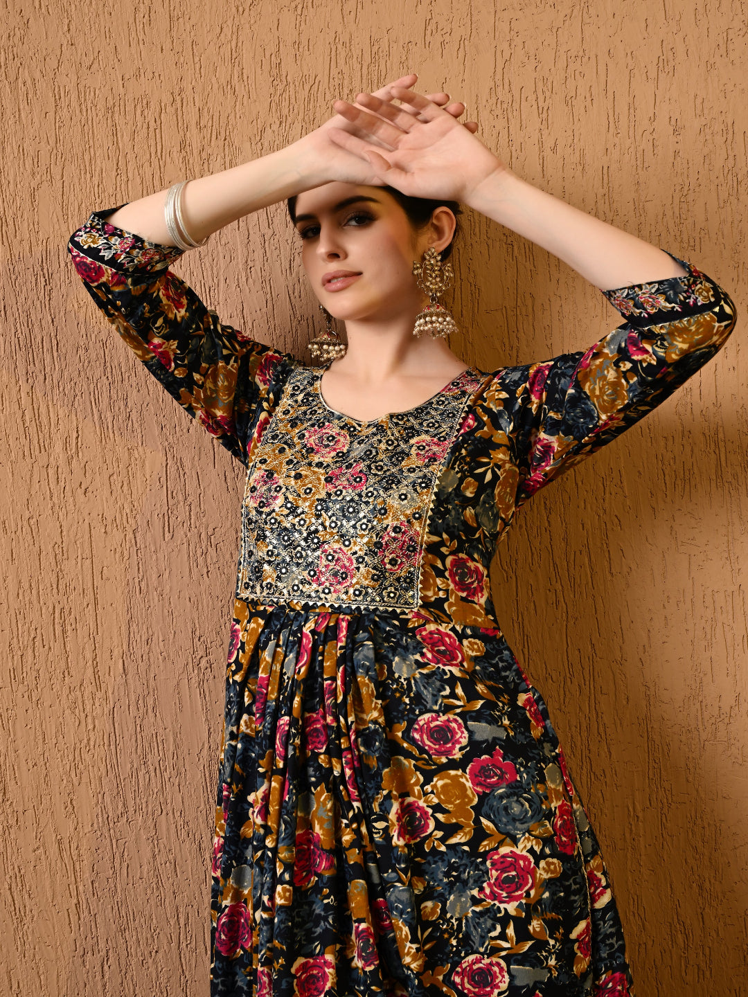 Woman wearing a floral dress against a wooden background