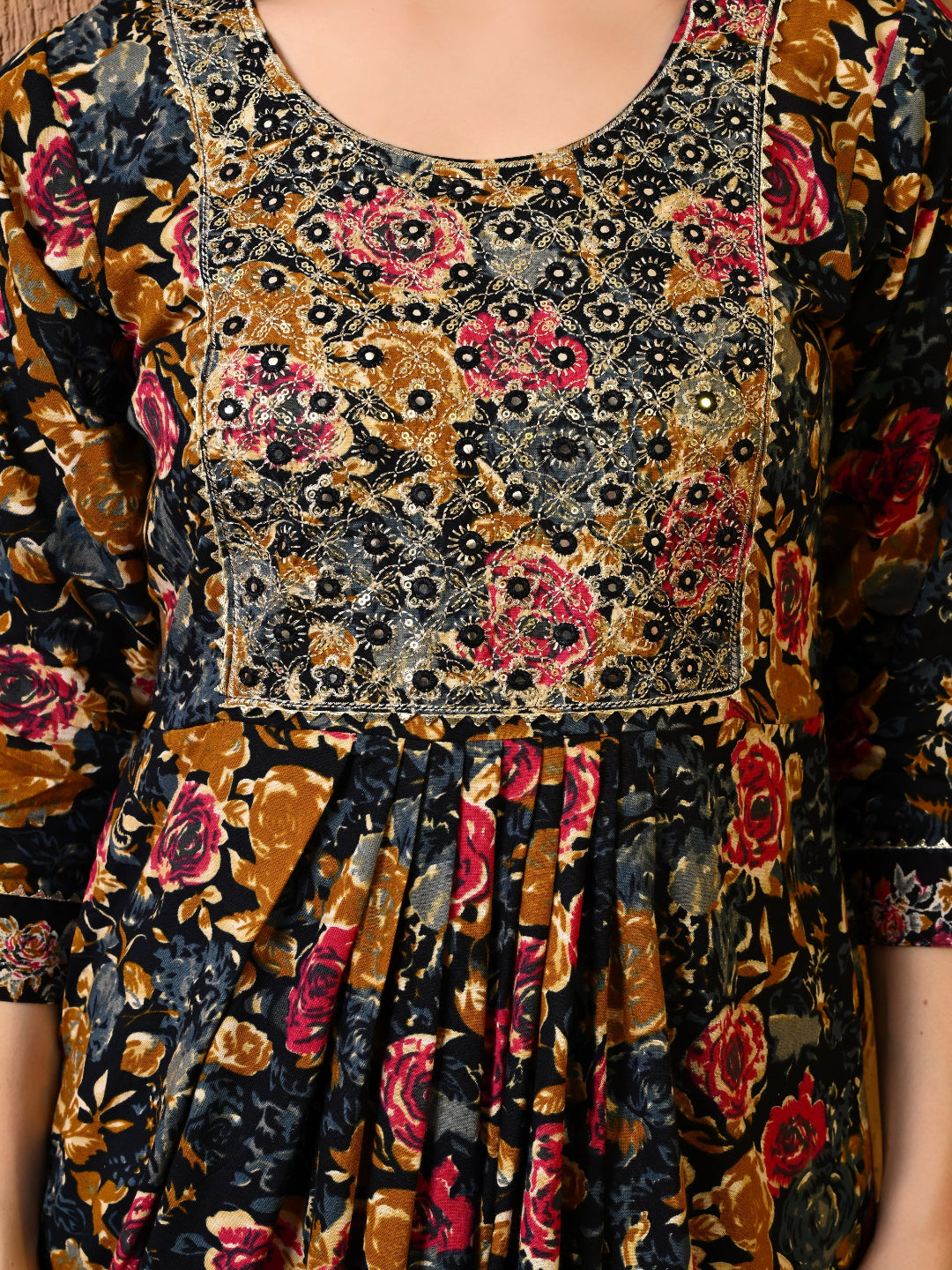 Close-up of a patterned dress with floral and abstract designs.