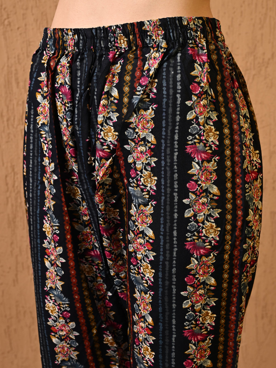 Floral striped pants on a beige background