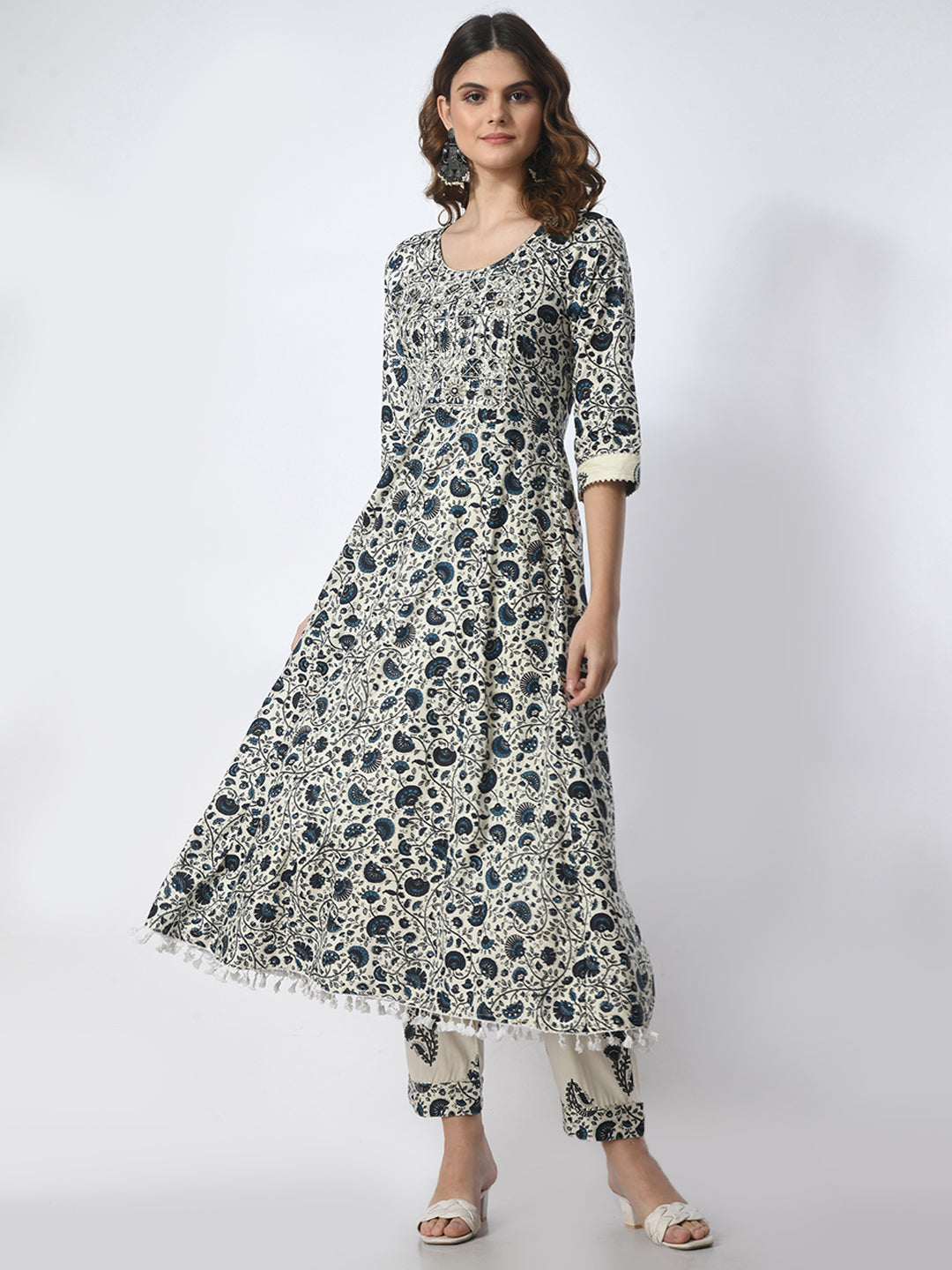 Woman wearing a floral patterned dress on a white background