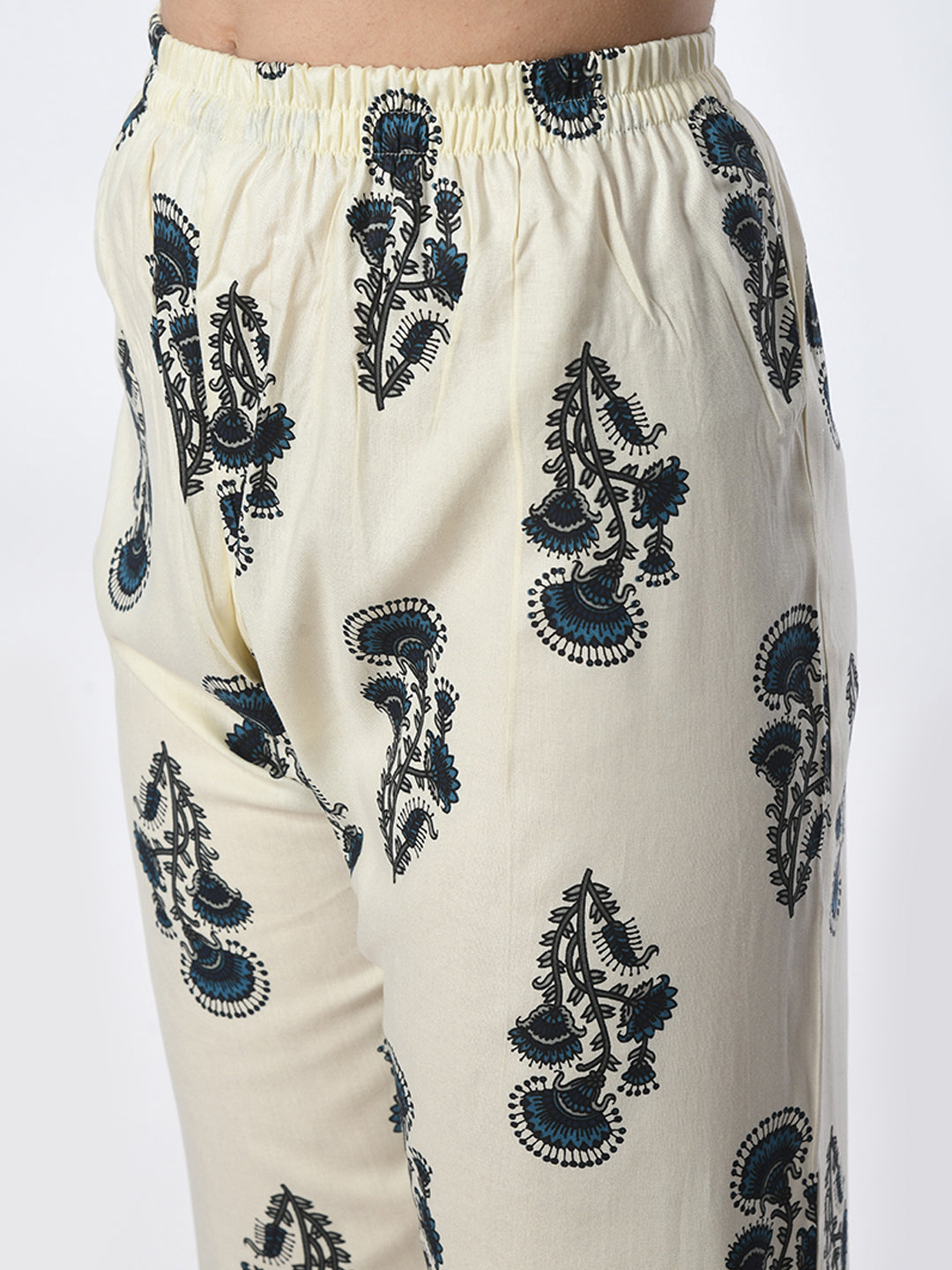 White pants with black floral embroidery on a white background