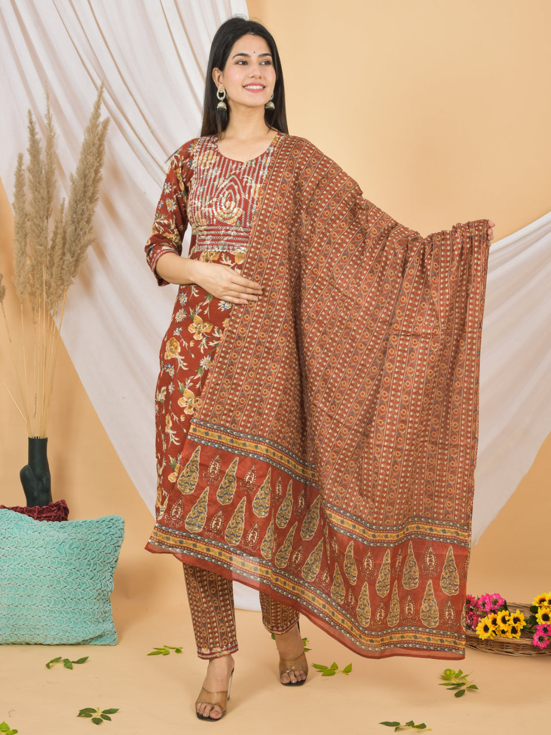 Woman wearing a patterned dress with a matching dupatta on a beige background > Mitrika