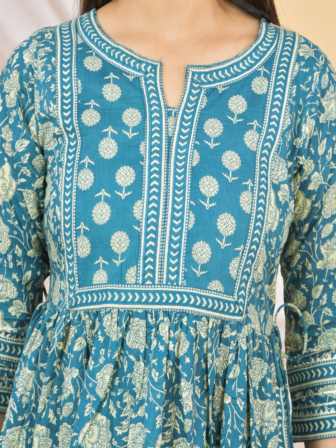 Blue dress with white floral pattern on a beige background