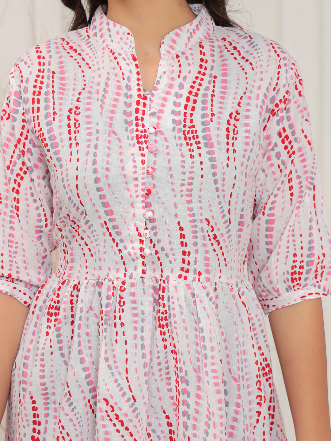 White shirt with red pattern worn by a person