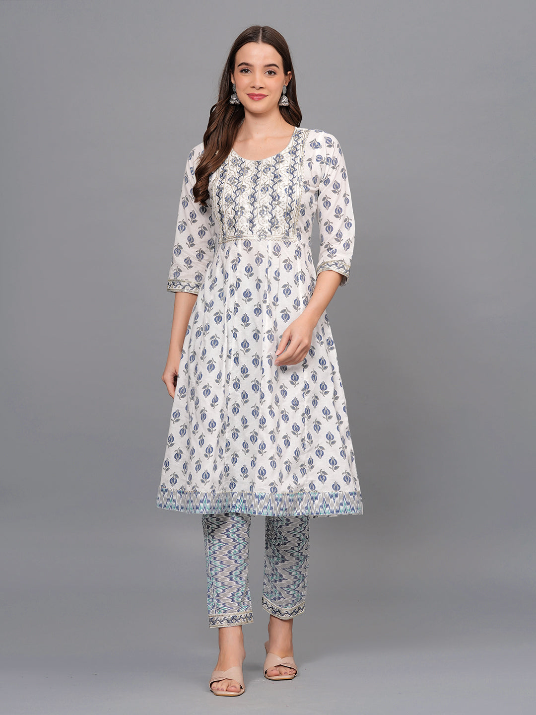 Woman wearing a floral dress and pants set on a gray background >Mitrika