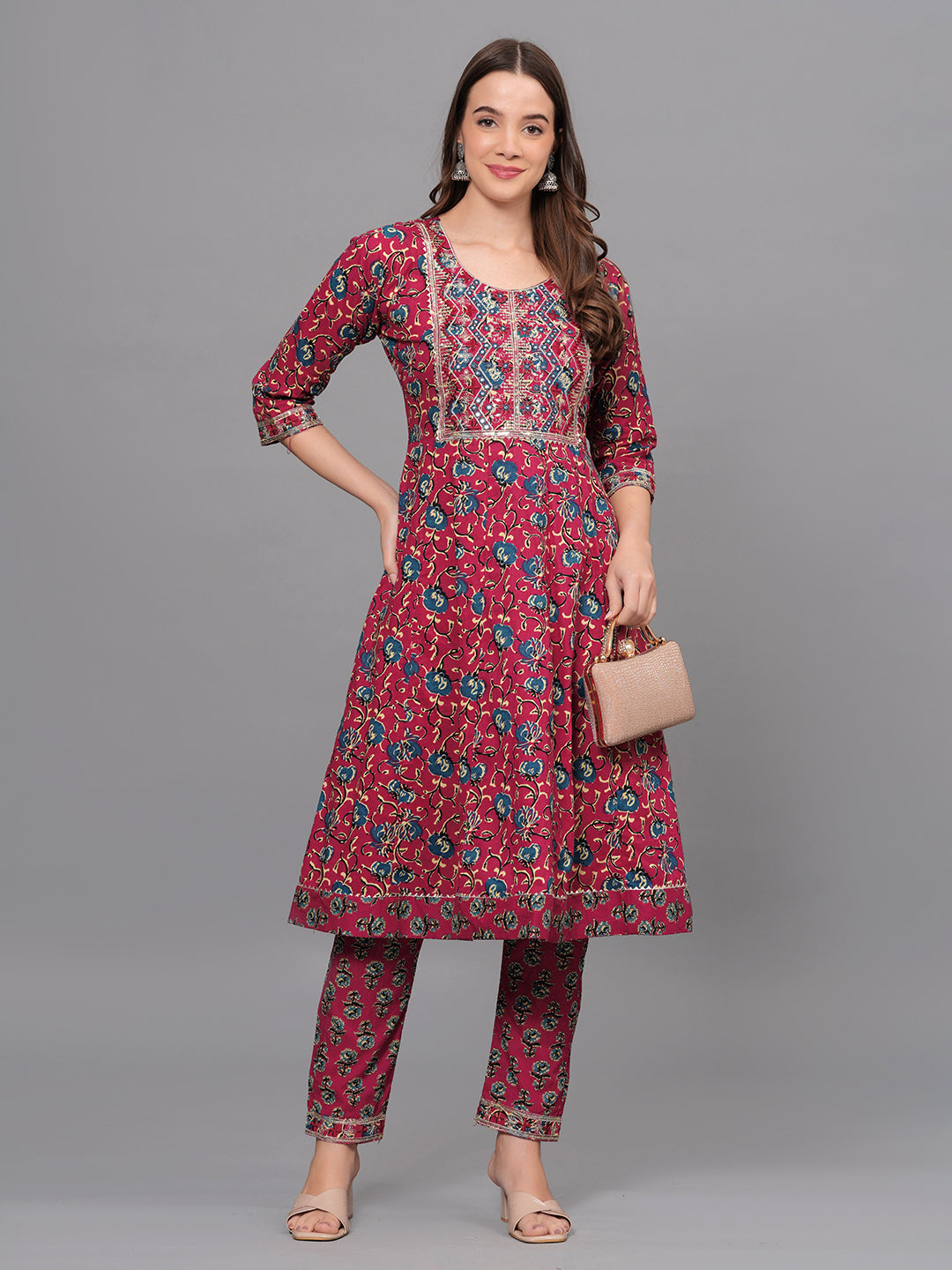 Woman wearing a red floral kurta with matching pants on a gray background > Mitrika