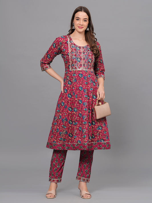 Woman wearing a red floral kurta with matching pants on a gray background > Mitrika