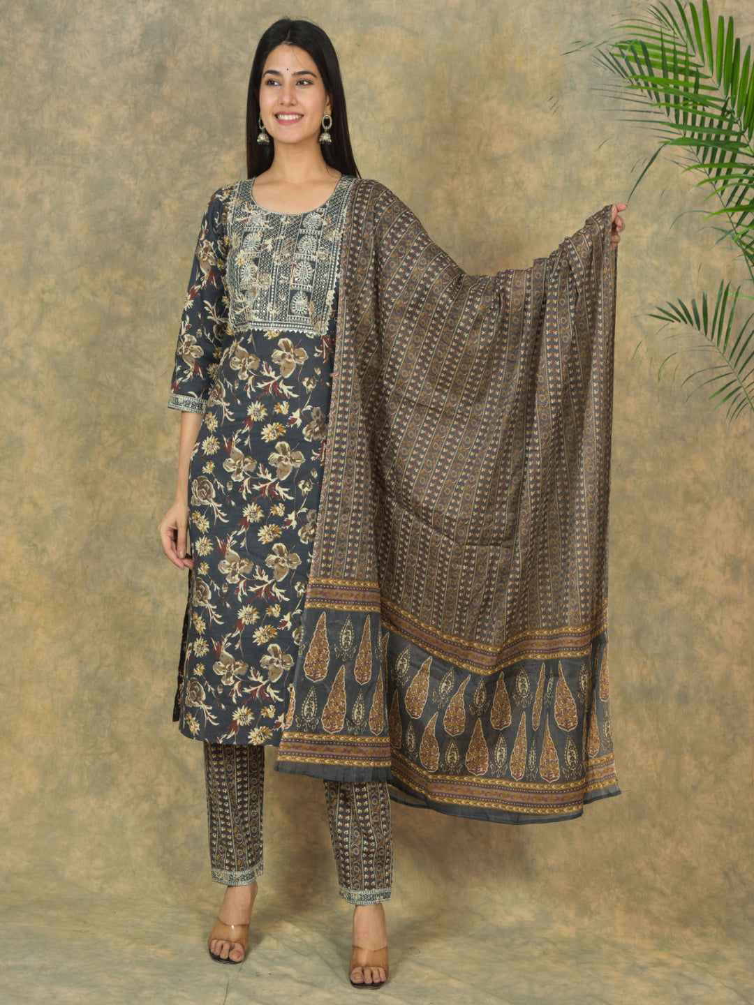 Woman holding a patterned dupatta with a matching outfit on a beige background > Mitrika