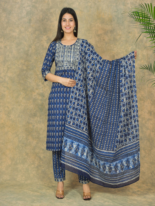 Woman holding a blue patterned dupatta against a beige background