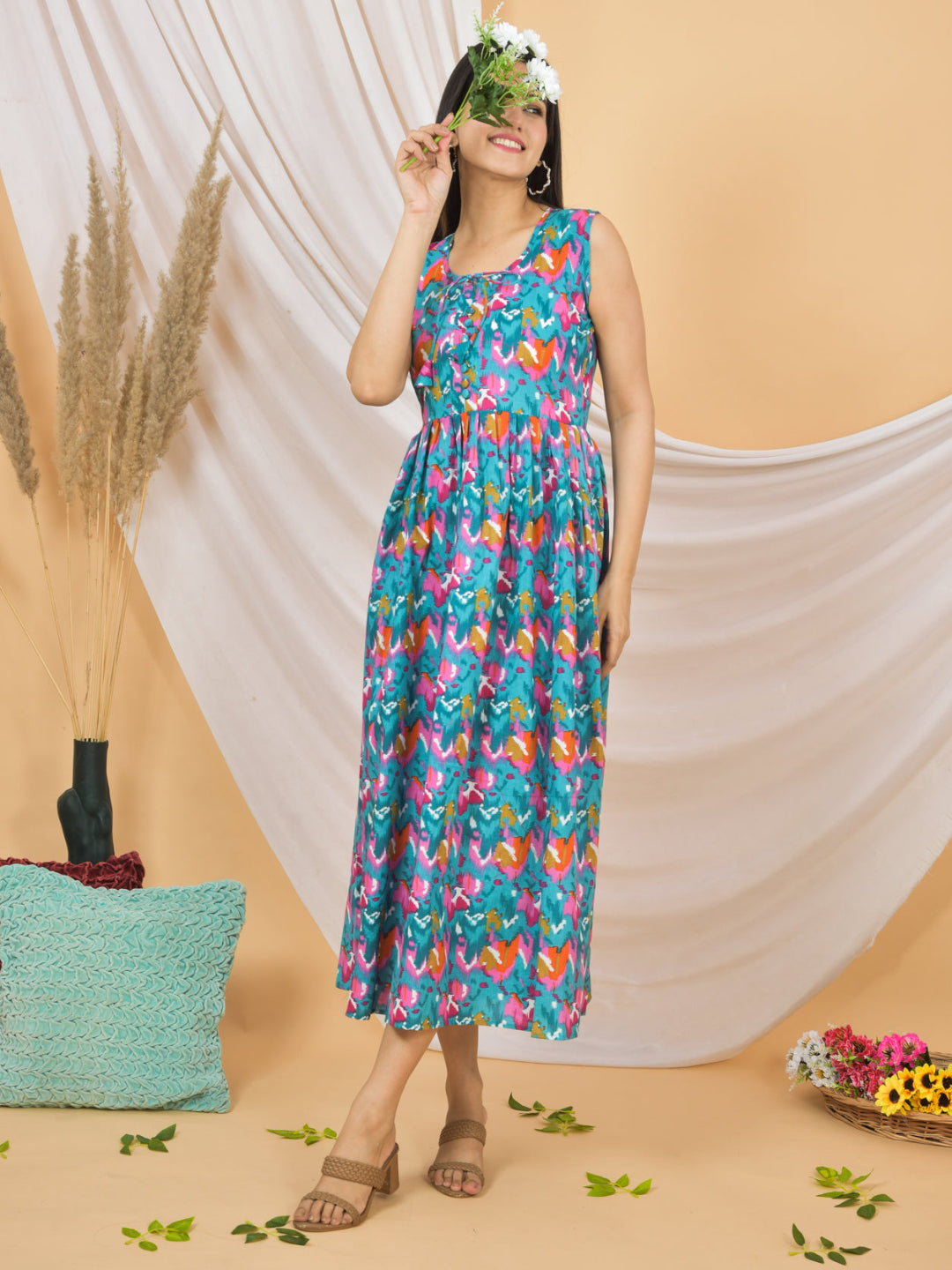 Woman wearing a colorful floral dress against a beige background