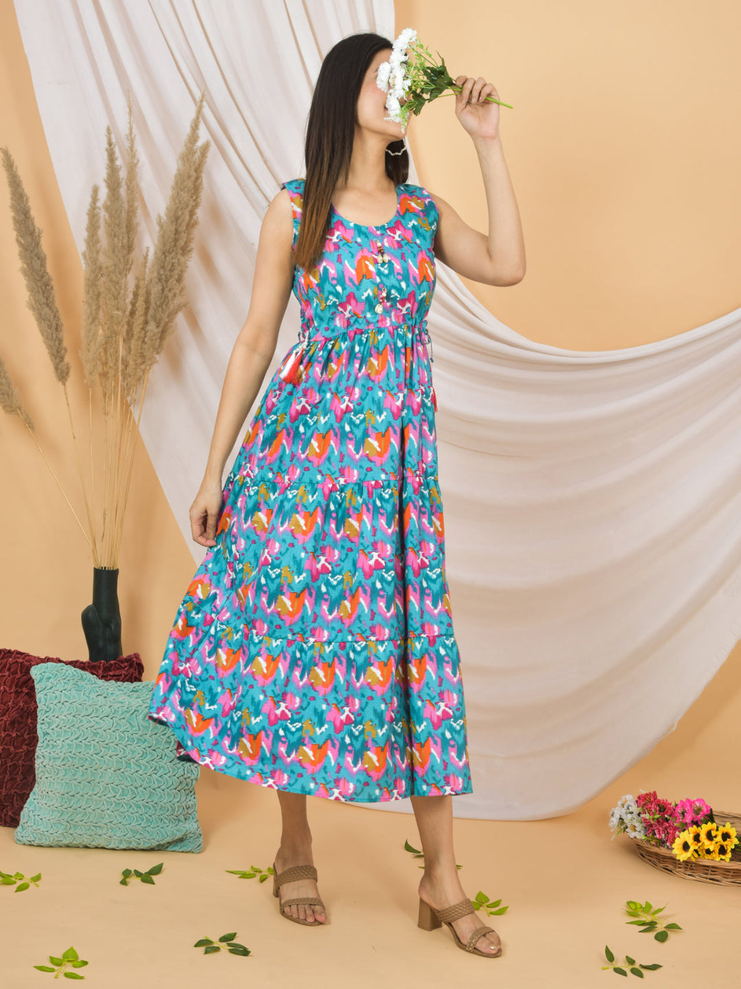 Woman wearing a colorful floral dress against a beige background