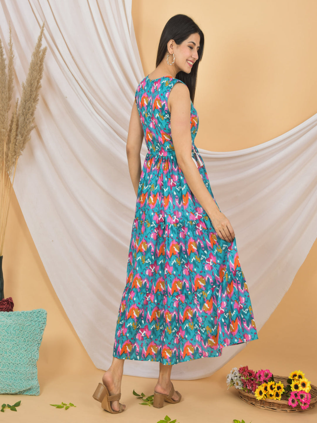 Woman wearing a colorful floral dress against a beige background