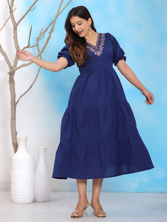 Navy blue embroidered midi dress, tiered cotton dress, V-neck puff sleeve dress, casual summer cotton dress, navy blue flared midi dress, ethnic boho style dress, navy tiered frock for women, embroidered neckline dress, short puff sleeve flared dress, comfortable cotton party wear dress, layered navy dress, casual outing midi dress, lightweight cotton festive wear, elegant navy bohemian dress. > Mitrika