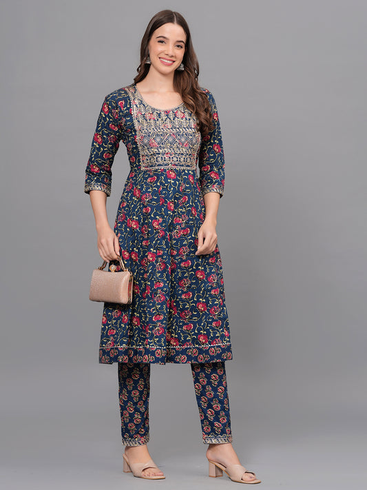 Woman wearing a navy blue floral outfit with a gray background > Mitrika