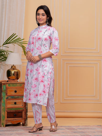 Woman wearing a floral kurta with a wooden side table and lamp in the background