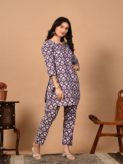 Woman wearing a patterned kurta with pants against a beige background
