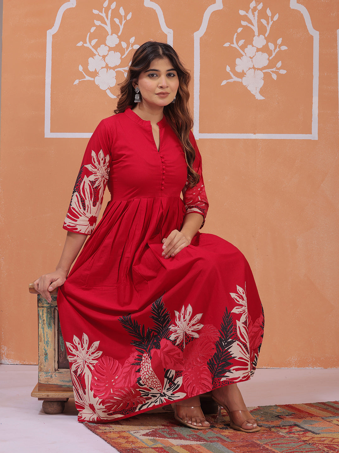 Woman in a red dress with floral patterns , 3/4 sleeve and mandarin collor fit and flare dress>Mitrika