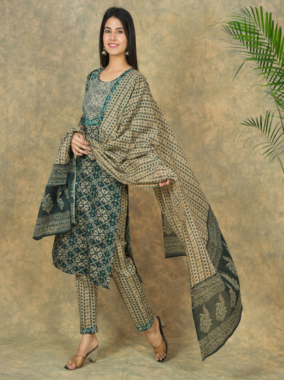 Woman wearing a traditional outfit with a patterned dupatta against a neutral background