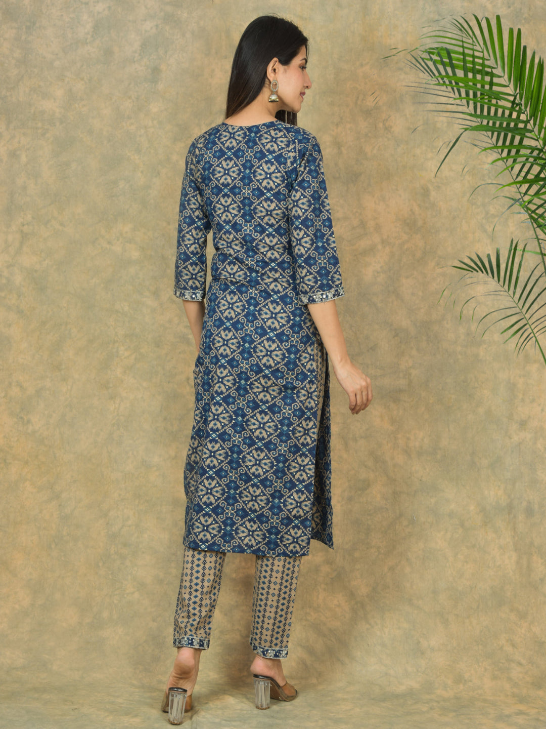 Woman wearing a blue patterned kurta with a beige background