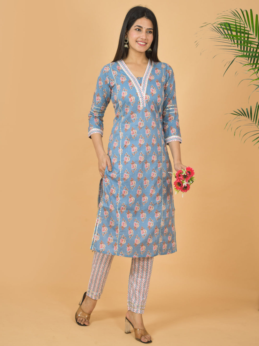 Woman wearing a blue floral kurta with white trim against a beige background > Mitrika