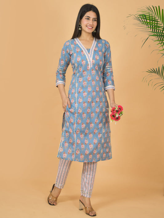Woman wearing a blue floral kurta with white trim against a beige background > Mitrika