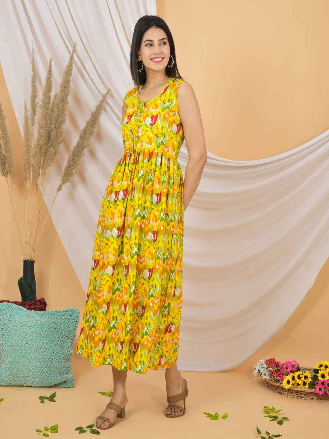 Woman wearing a yellow floral dress standing against a beige background with decorative elements.