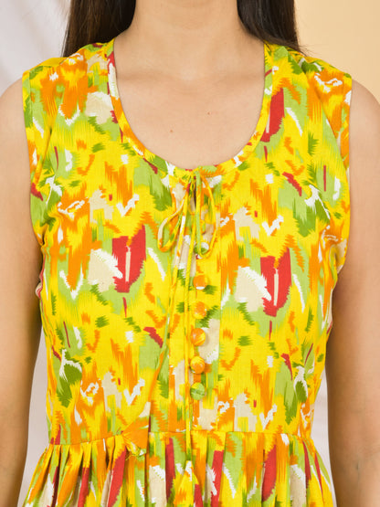 Yellow sleeveless top with colorful floral pattern on a beige background