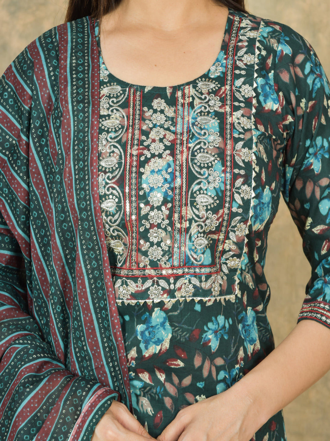 Close-up of a person wearing a patterned outfit with floral and striped designs.