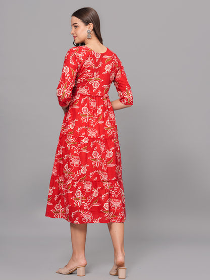 Woman wearing a red floral dress on a gray background