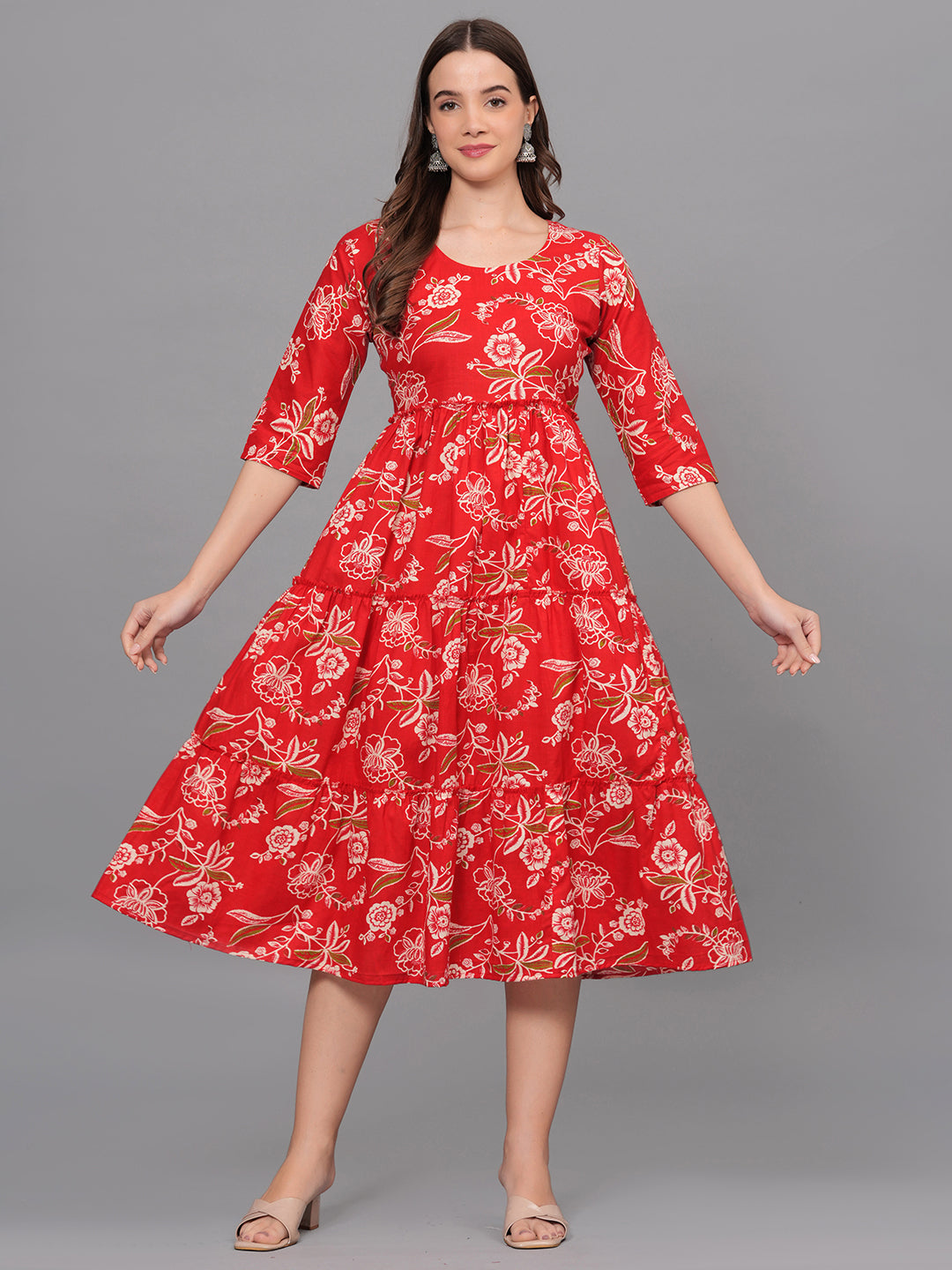 Woman wearing a red floral dress on a gray background