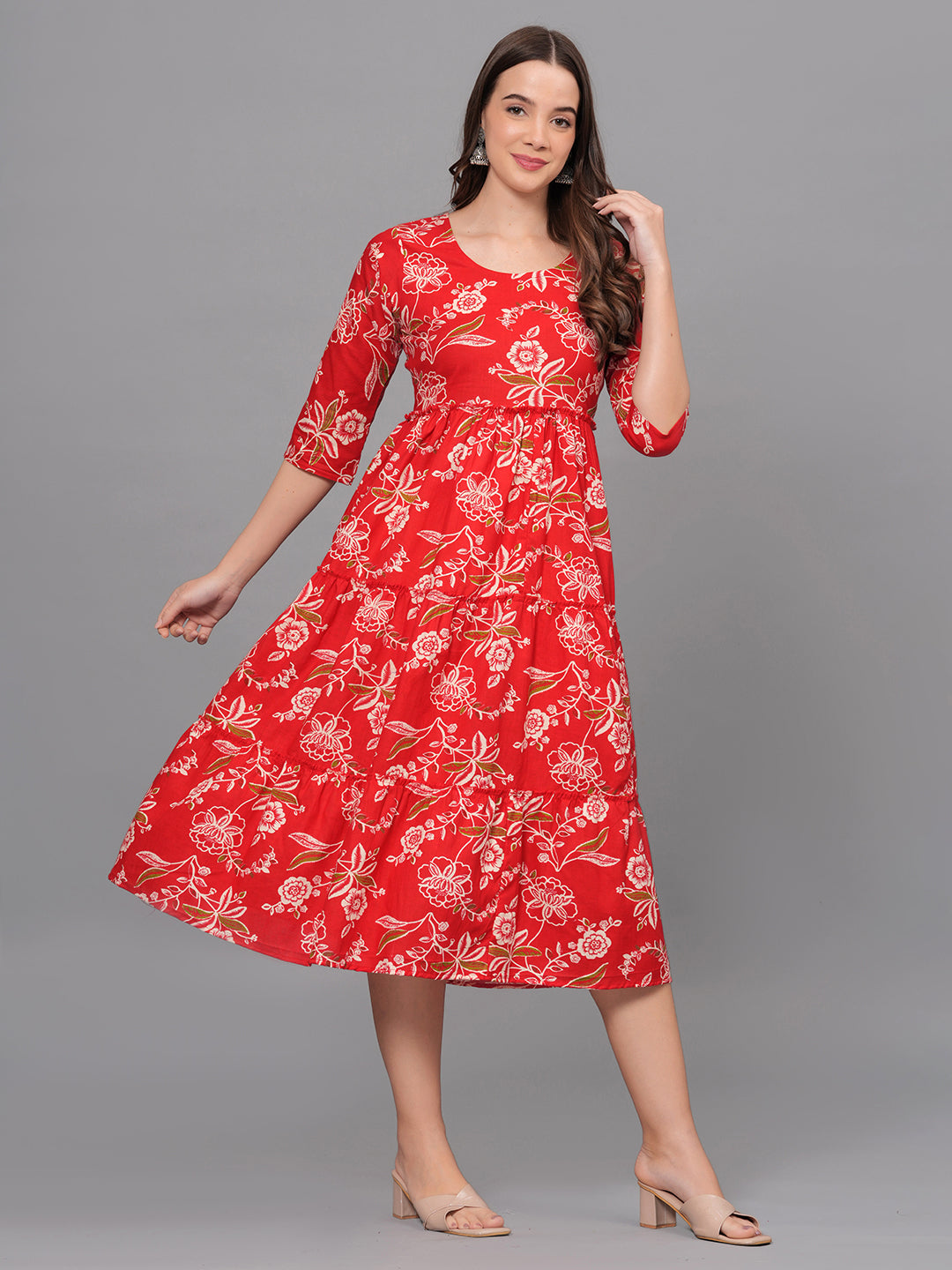 Woman wearing a red floral dress on a gray background
