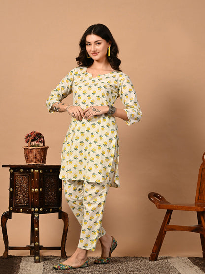 Woman wearing a floral kurta with pants against a beige background