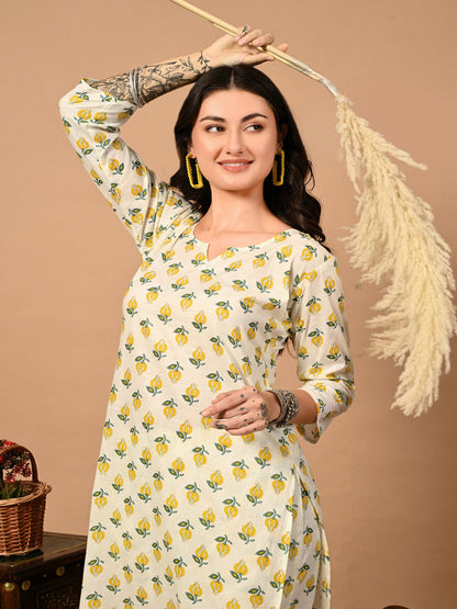Woman wearing a white dress with yellow floral patterns against a beige background