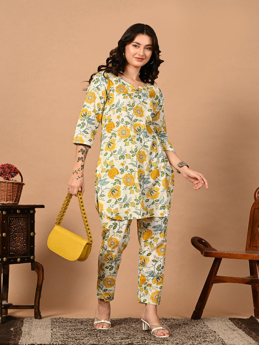 Woman wearing a floral outfit with a yellow bag against a beige background > Mitrika