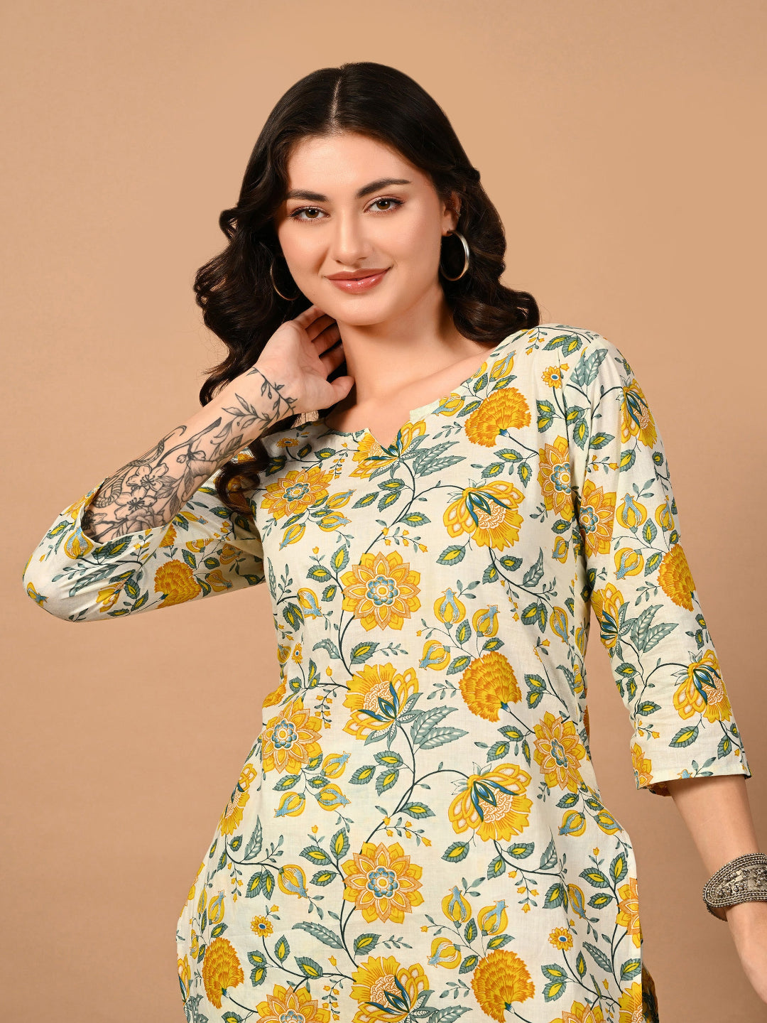 Woman wearing a floral dress with yellow flowers on a beige background